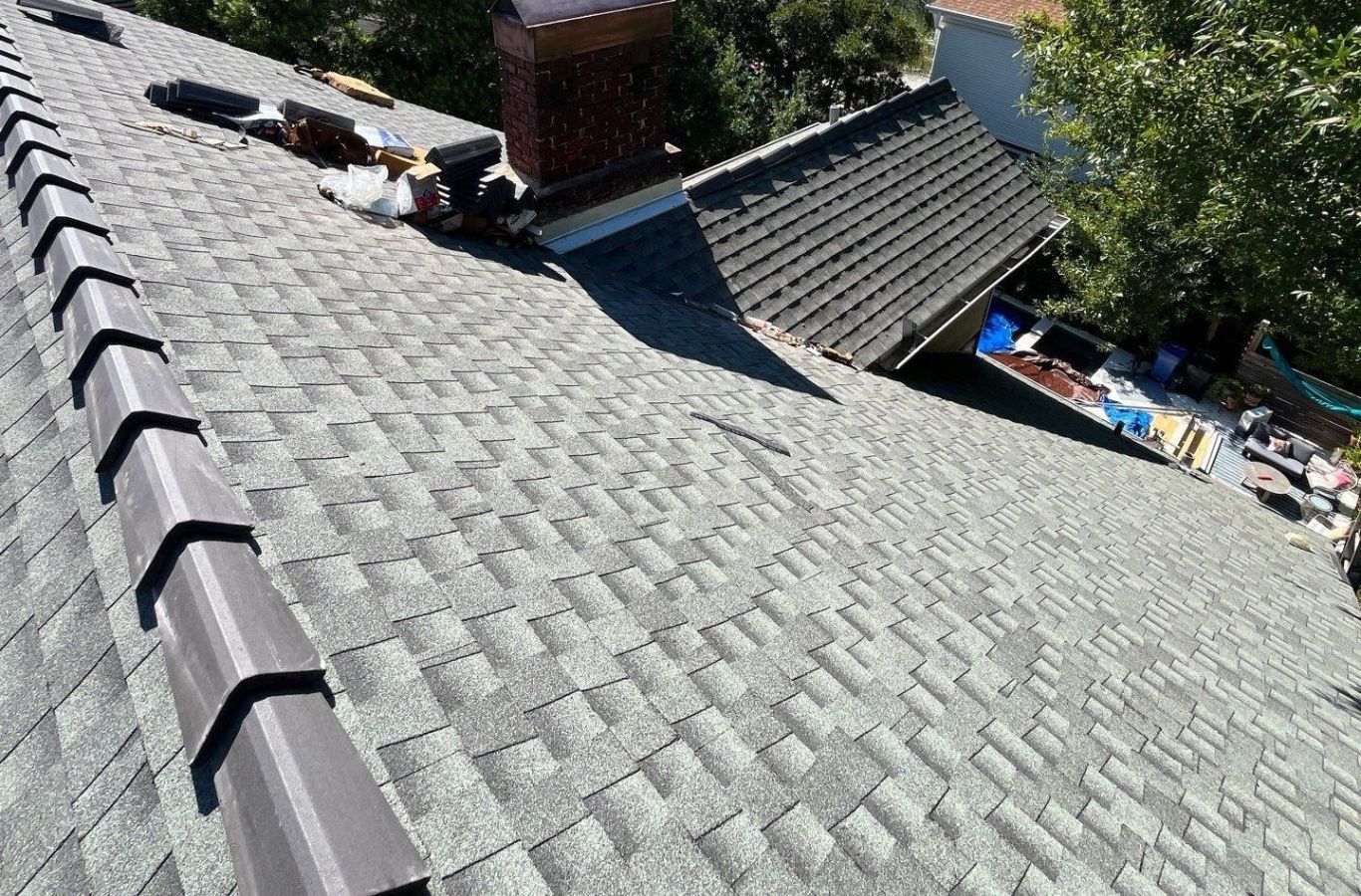 A satisfied homeowner in Nampa, ID admiring their newly installed roof, showcasing the high standards of Kodiak Roofing’s work. Roof Replacement near me.